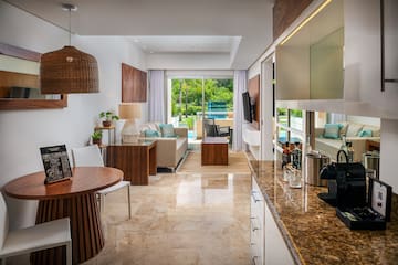 a room with a table and chairs and a television