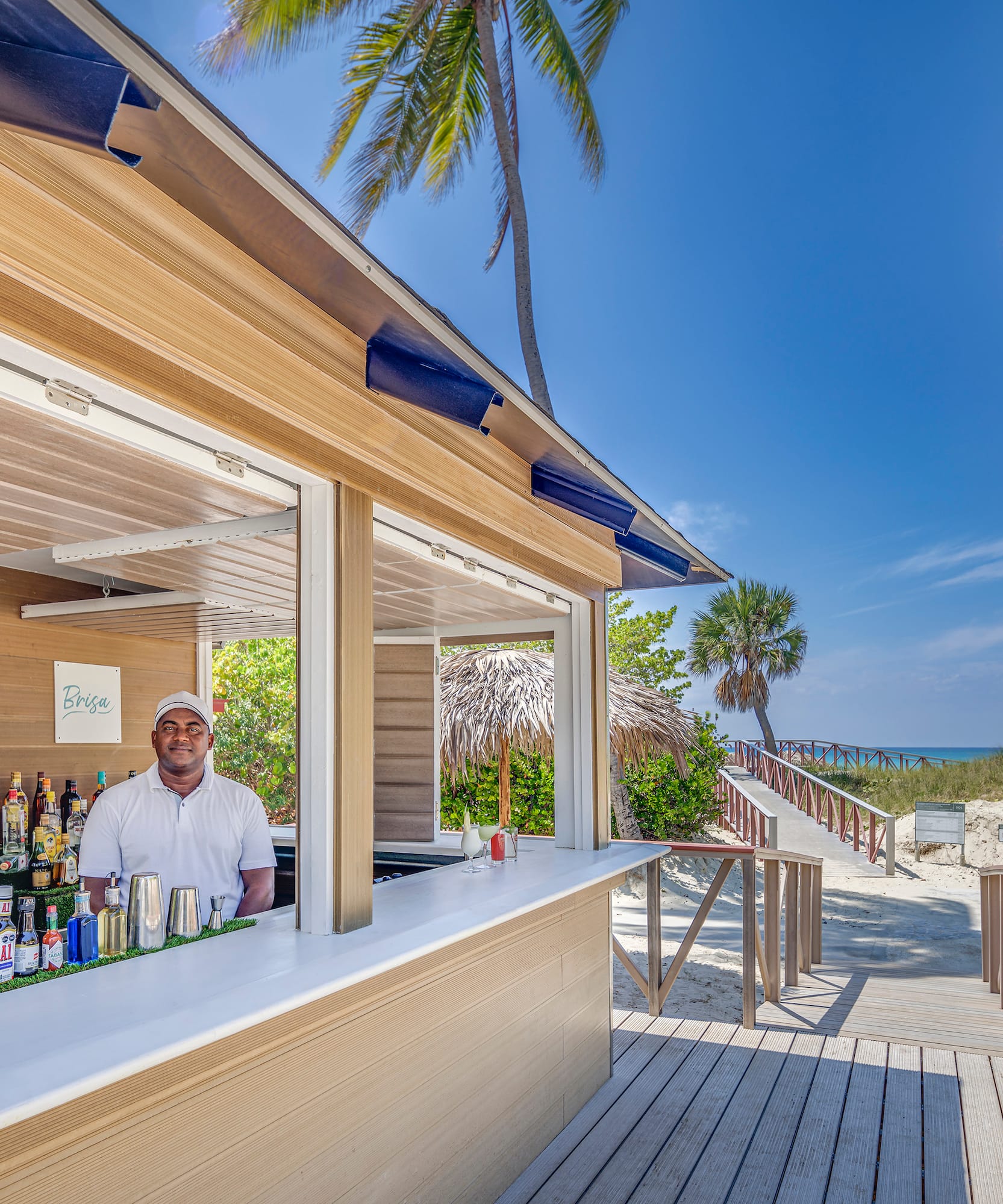 a man standing behind a bar