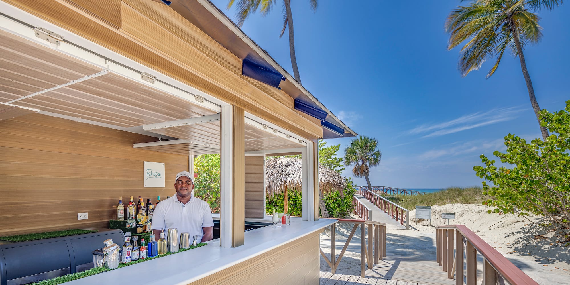 a man standing behind a bar