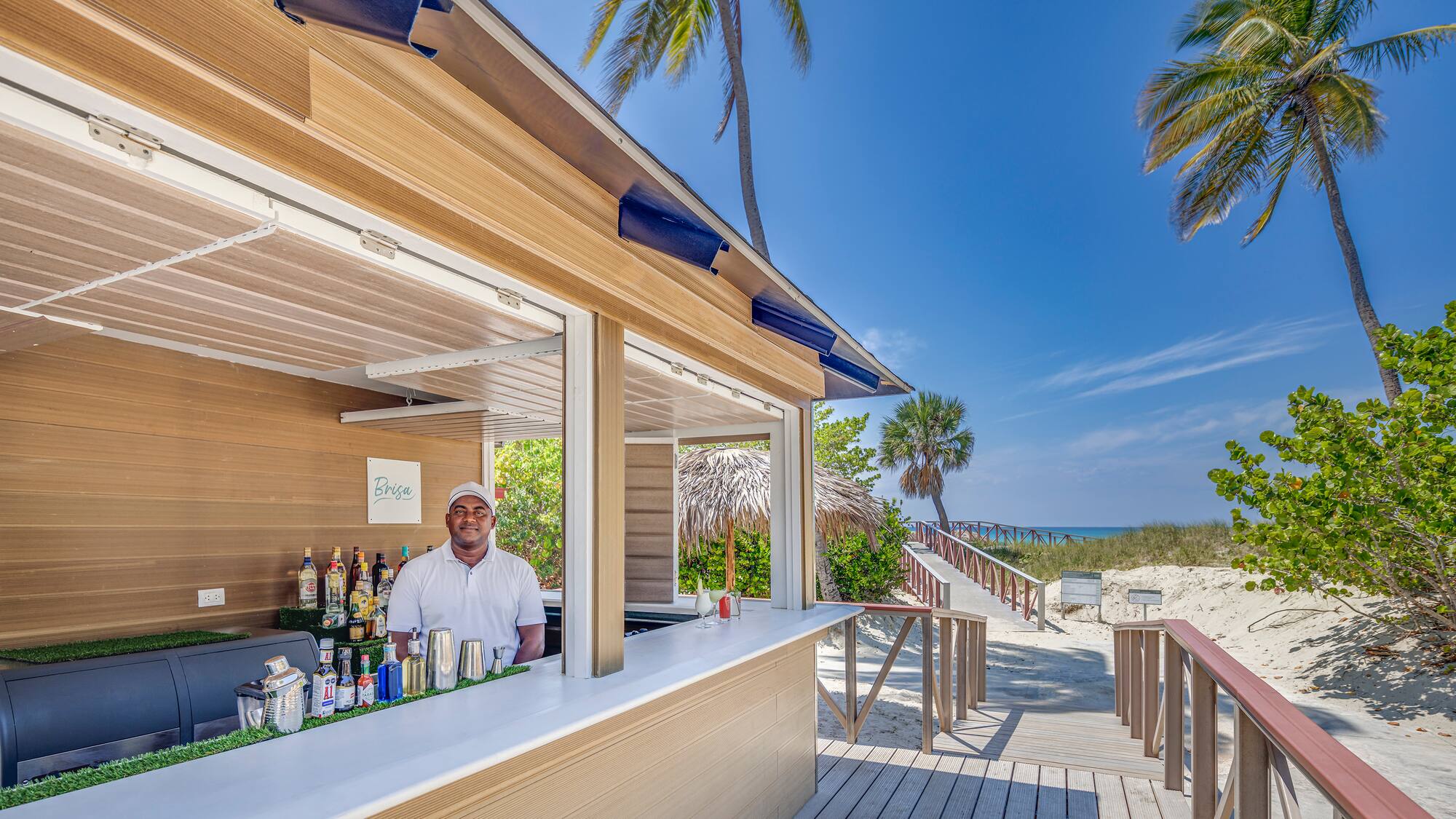 a man standing behind a bar