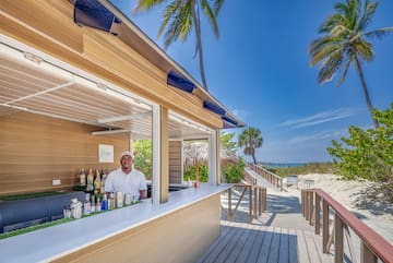 a man standing behind a bar