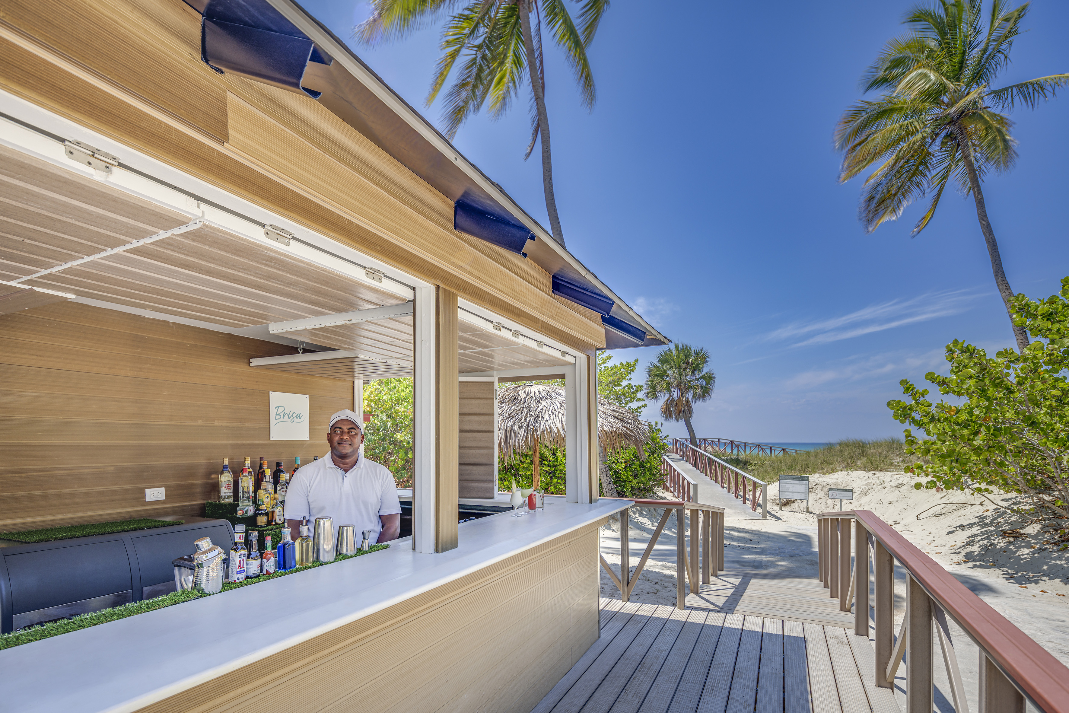 a man standing behind a bar