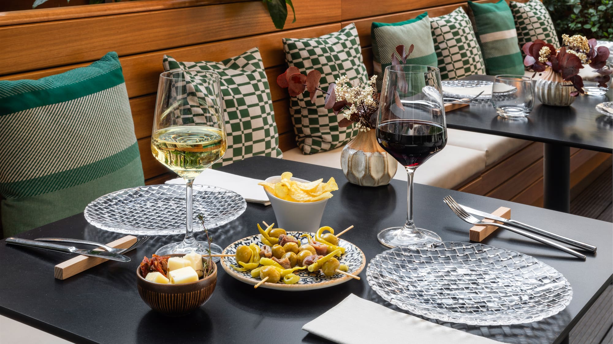 a table with food and glasses of wine