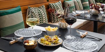 a table with food and glasses of wine