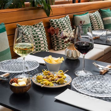 a table with food and glasses of wine