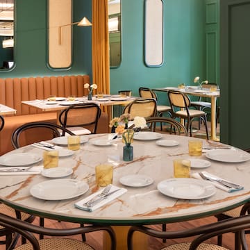 a table with plates and silverware in a restaurant