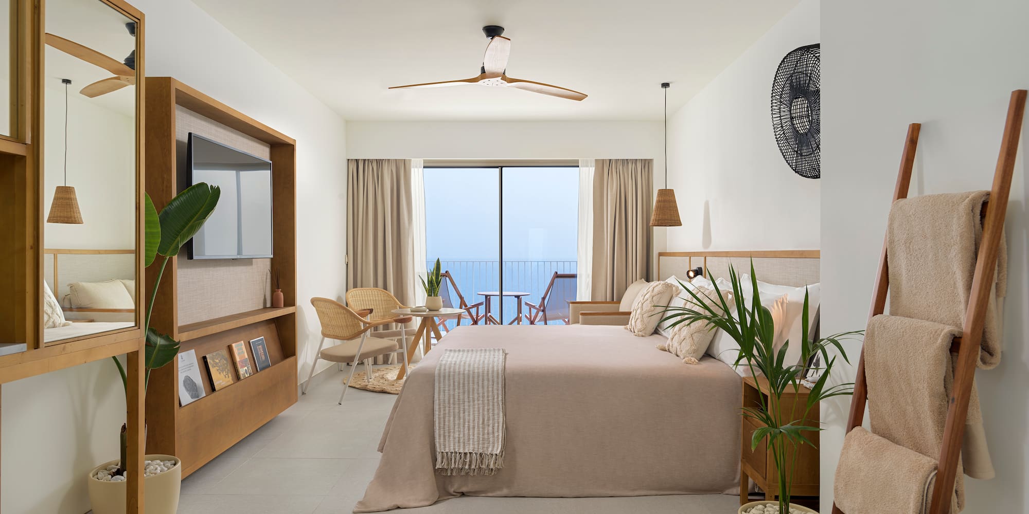 a bedroom with a bed and chairs