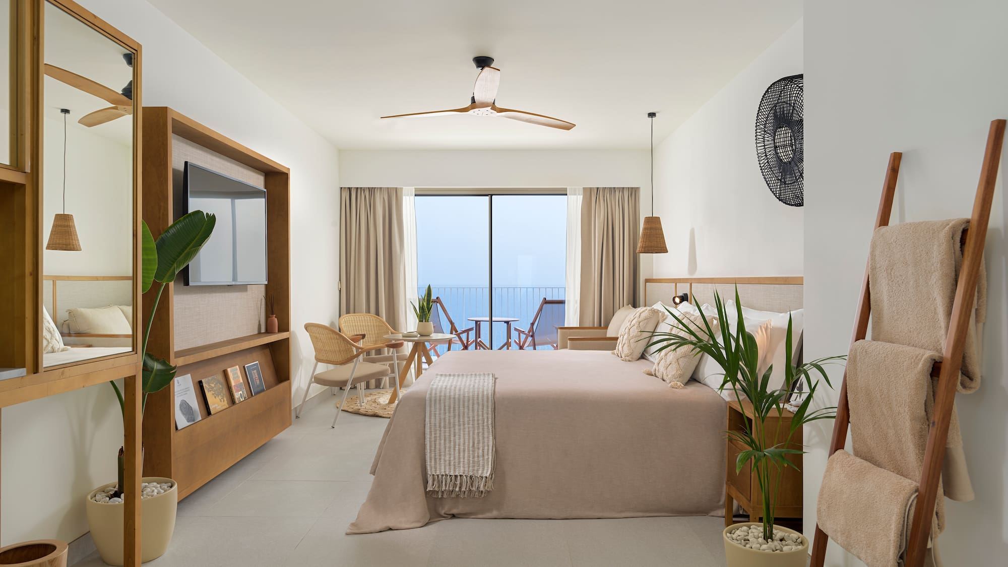 a bedroom with a bed and chairs