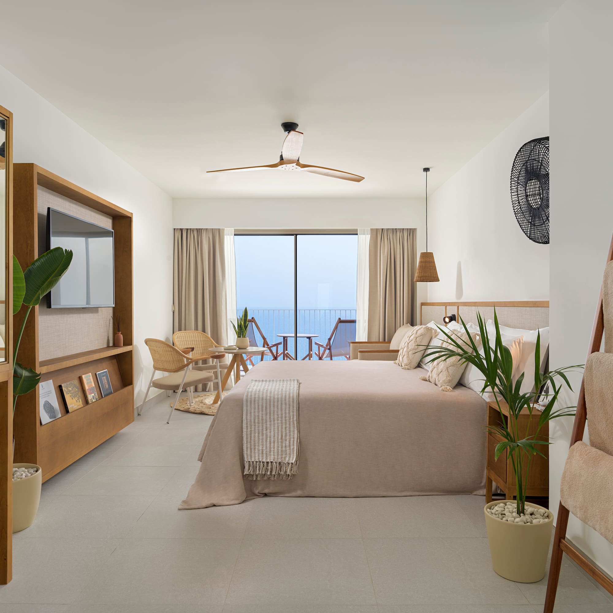 a bedroom with a bed and chairs