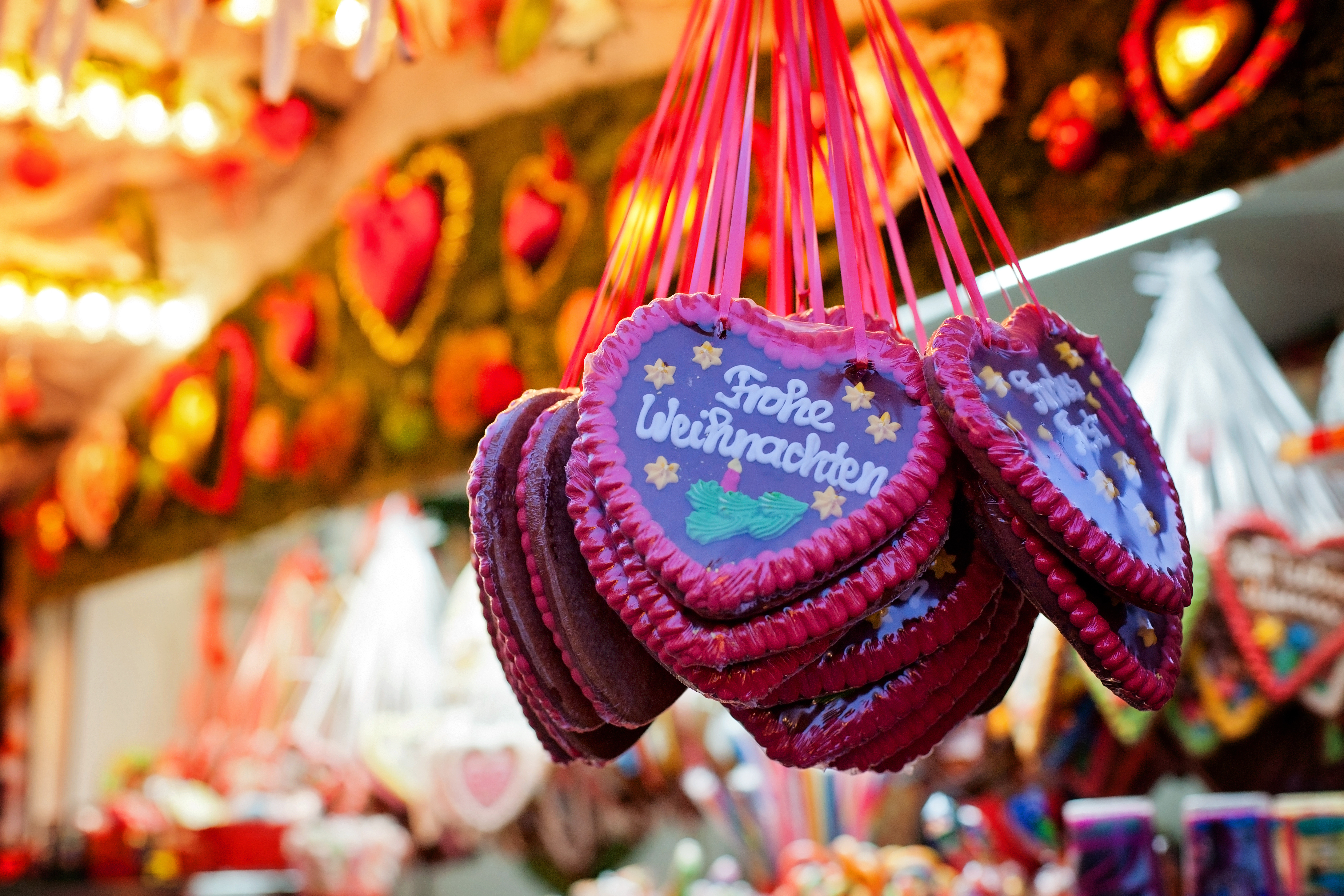 German gingerbread hearts "Frohe Weihnachten" hanging at Christmas market.