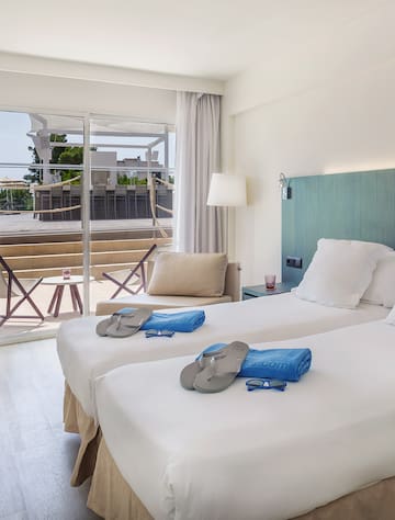 a room with two beds and a glass door