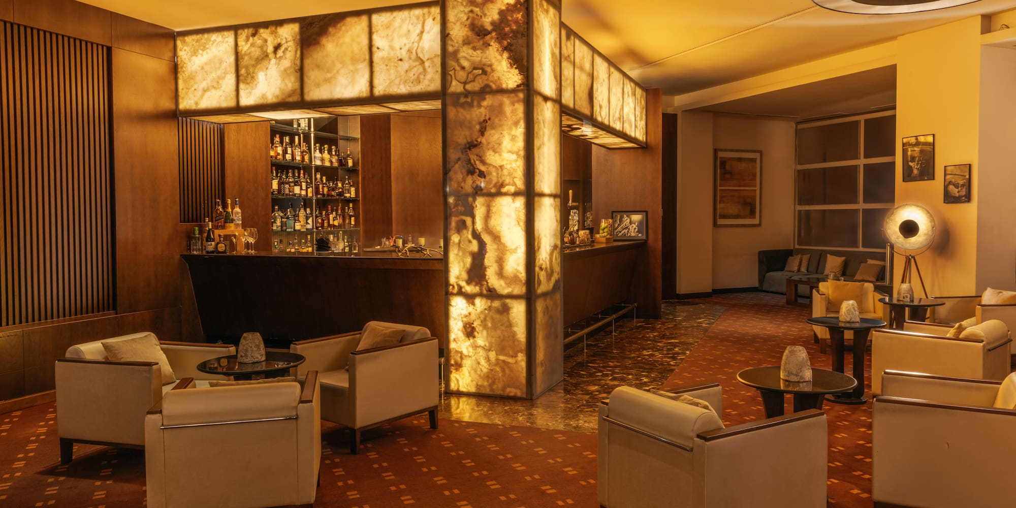 a room with a bar and chairs