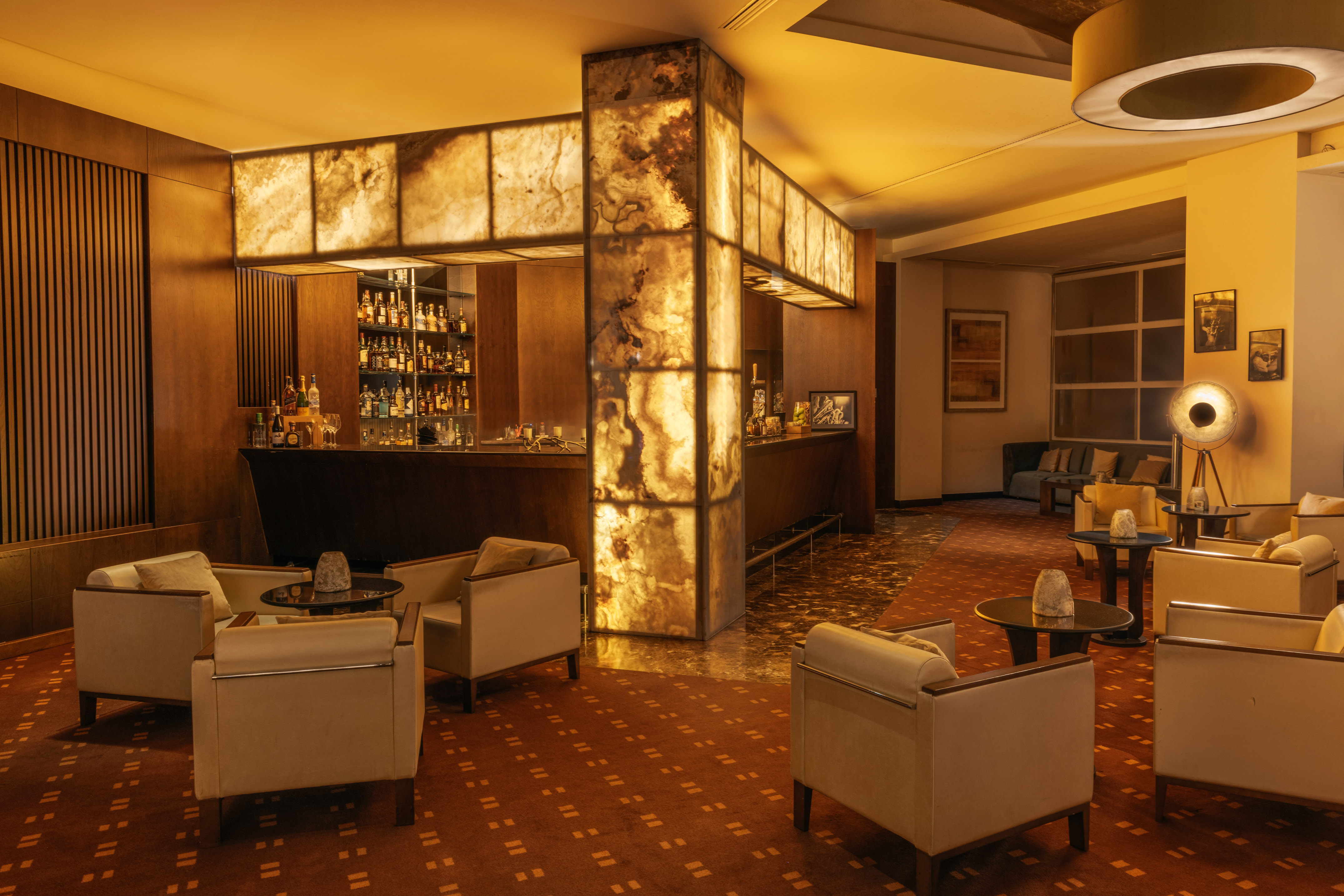 a room with a bar and chairs