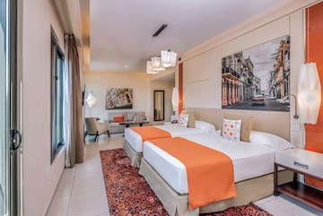 a room with two beds and a picture on the wall