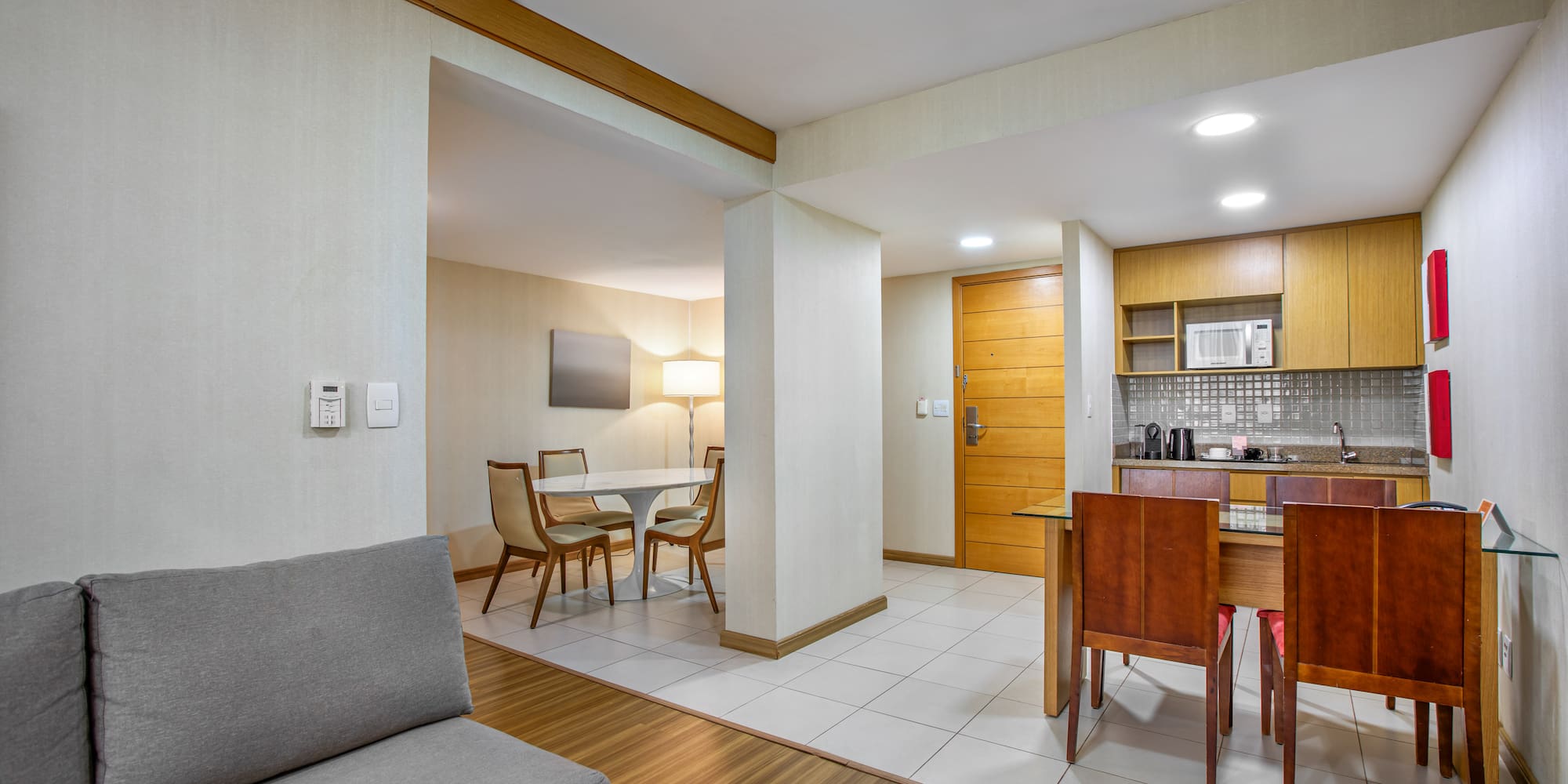 Apartment suite with living area, dining space, and modern kitchenette.