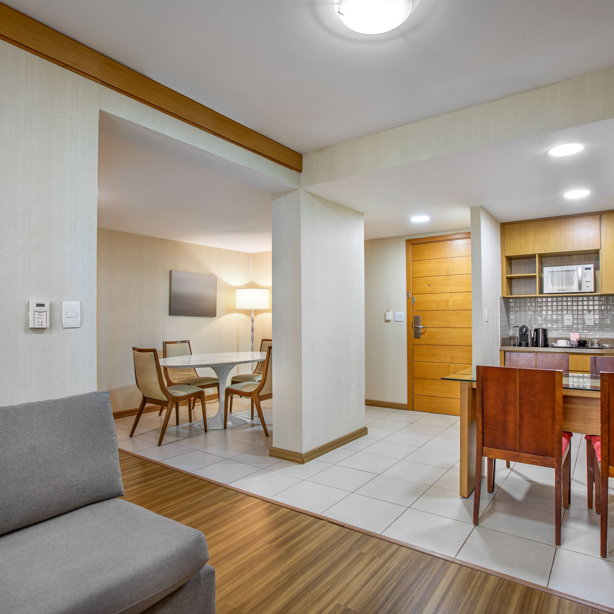Apartment suite with living area, dining space, and modern kitchenette.