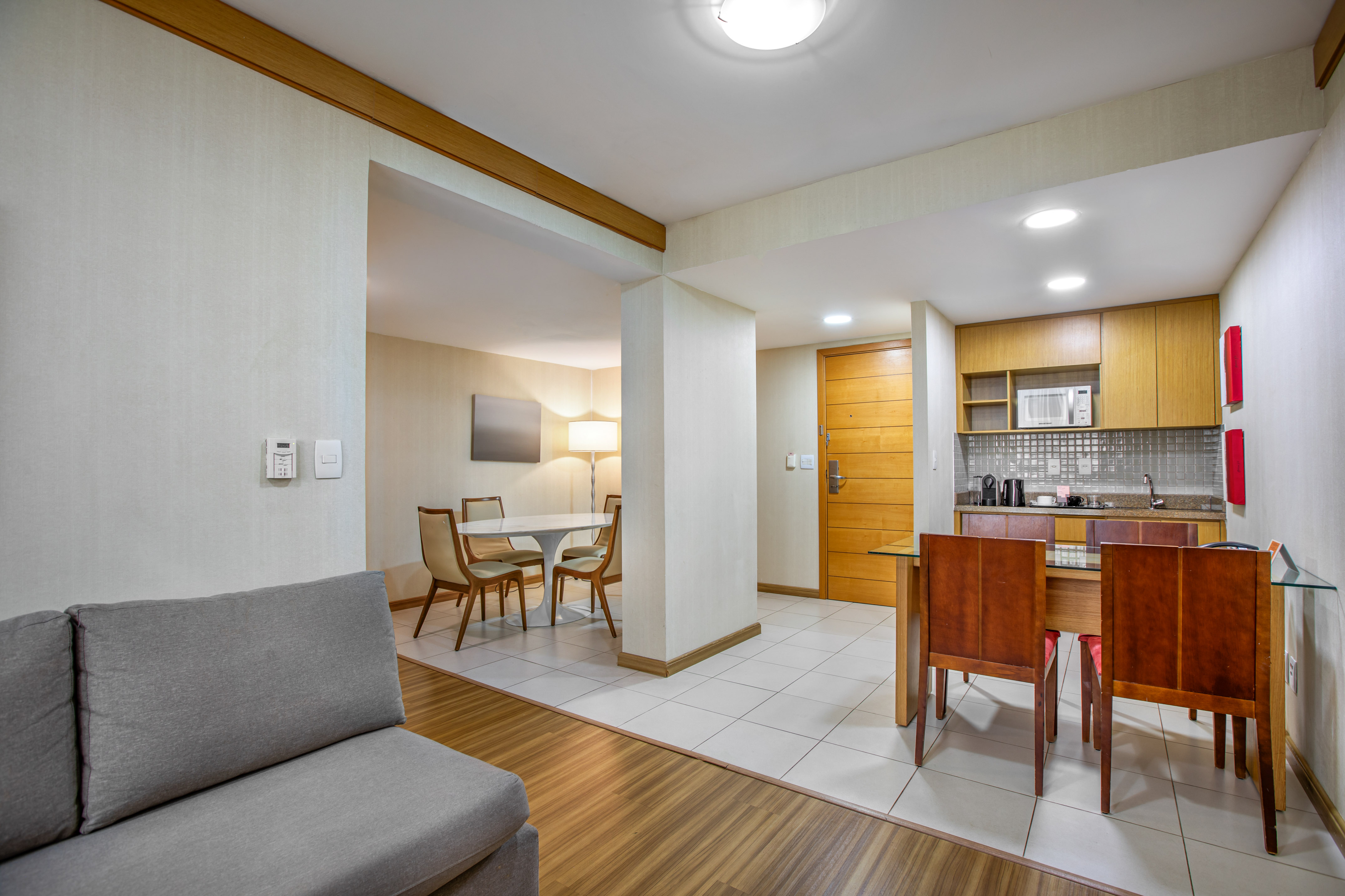 Apartment suite with living area, dining space, and modern kitchenette.