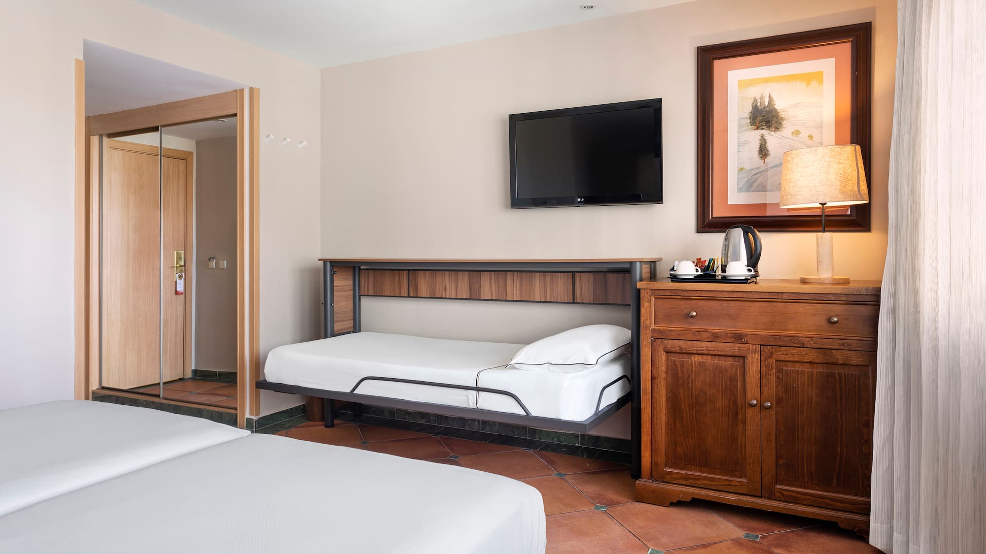 a room with two beds and a television