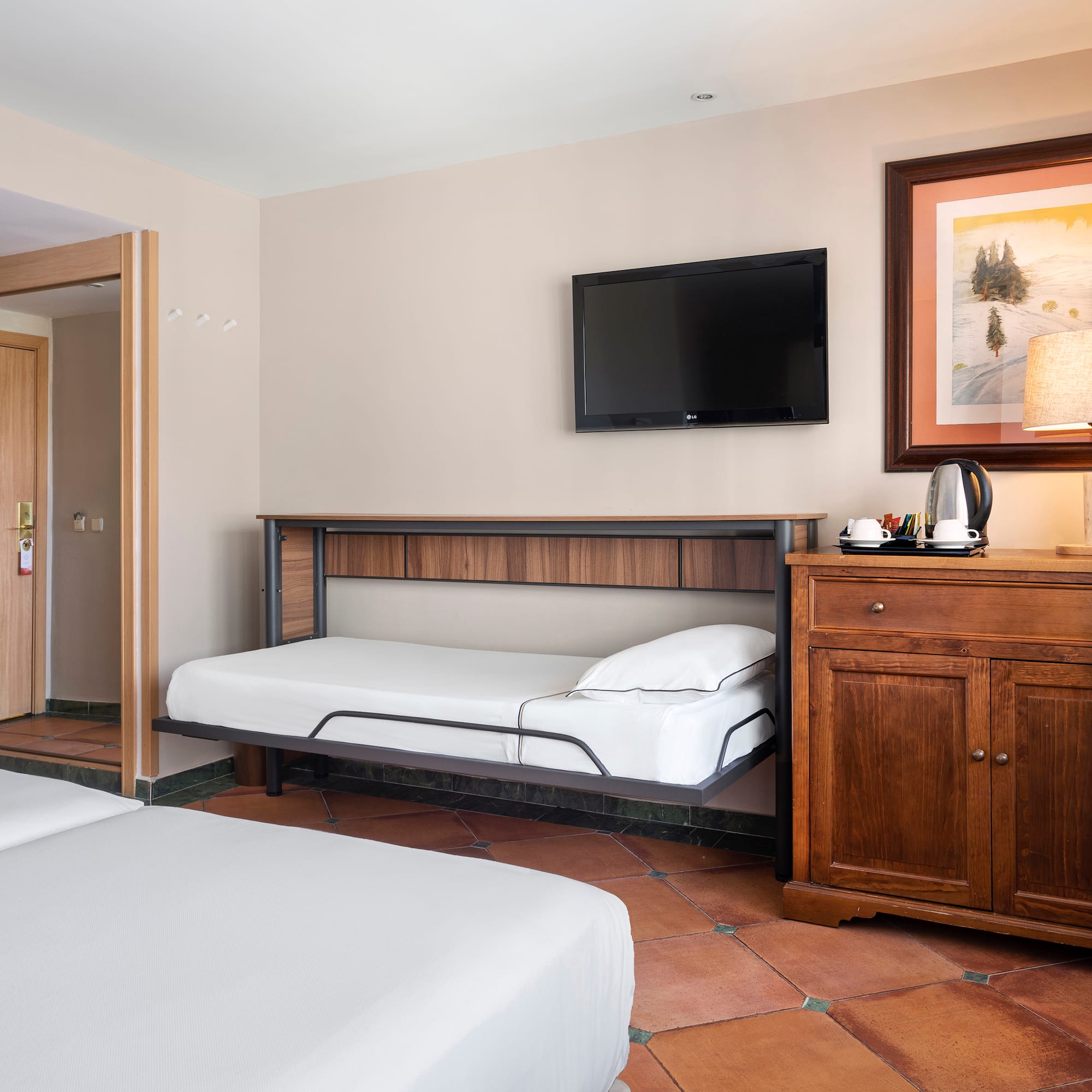 a room with two beds and a television