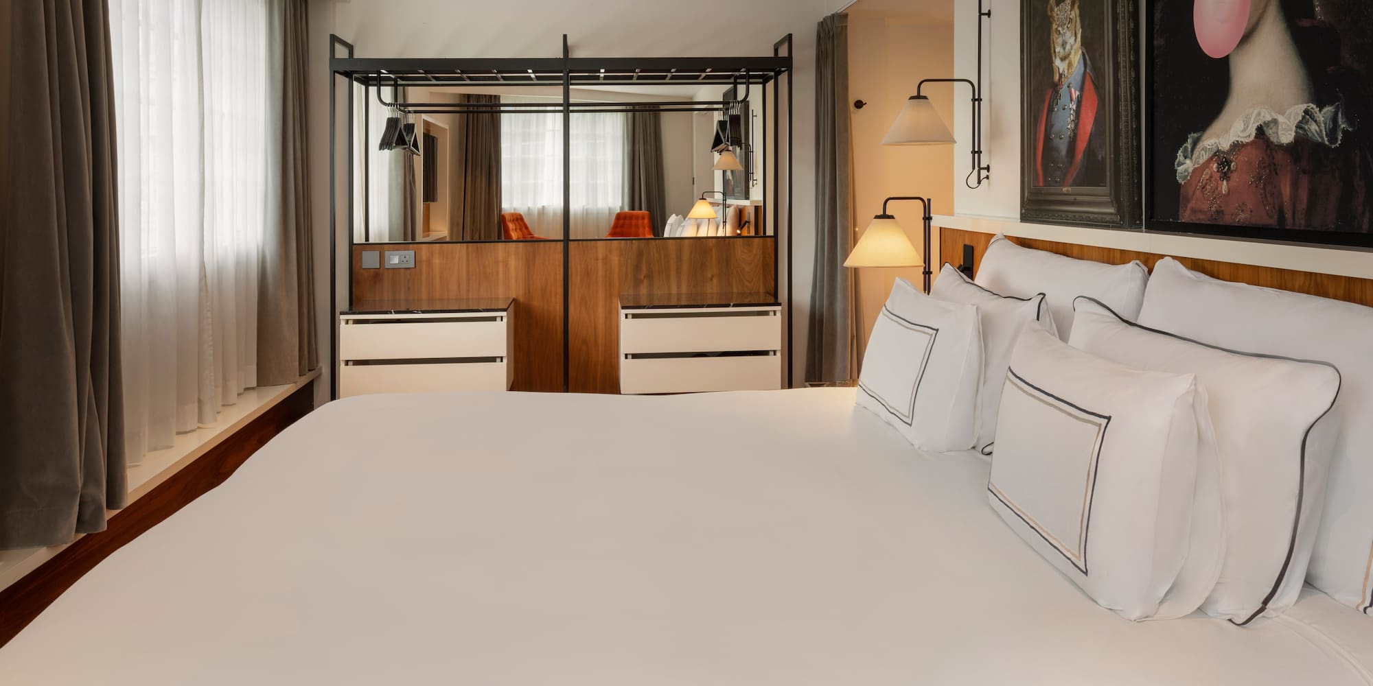 Stylish hotel bedroom with a large bed, modern wardrobe, and unique wall art.