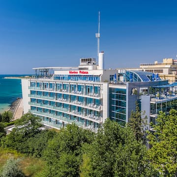 a building with many windows and a body of water