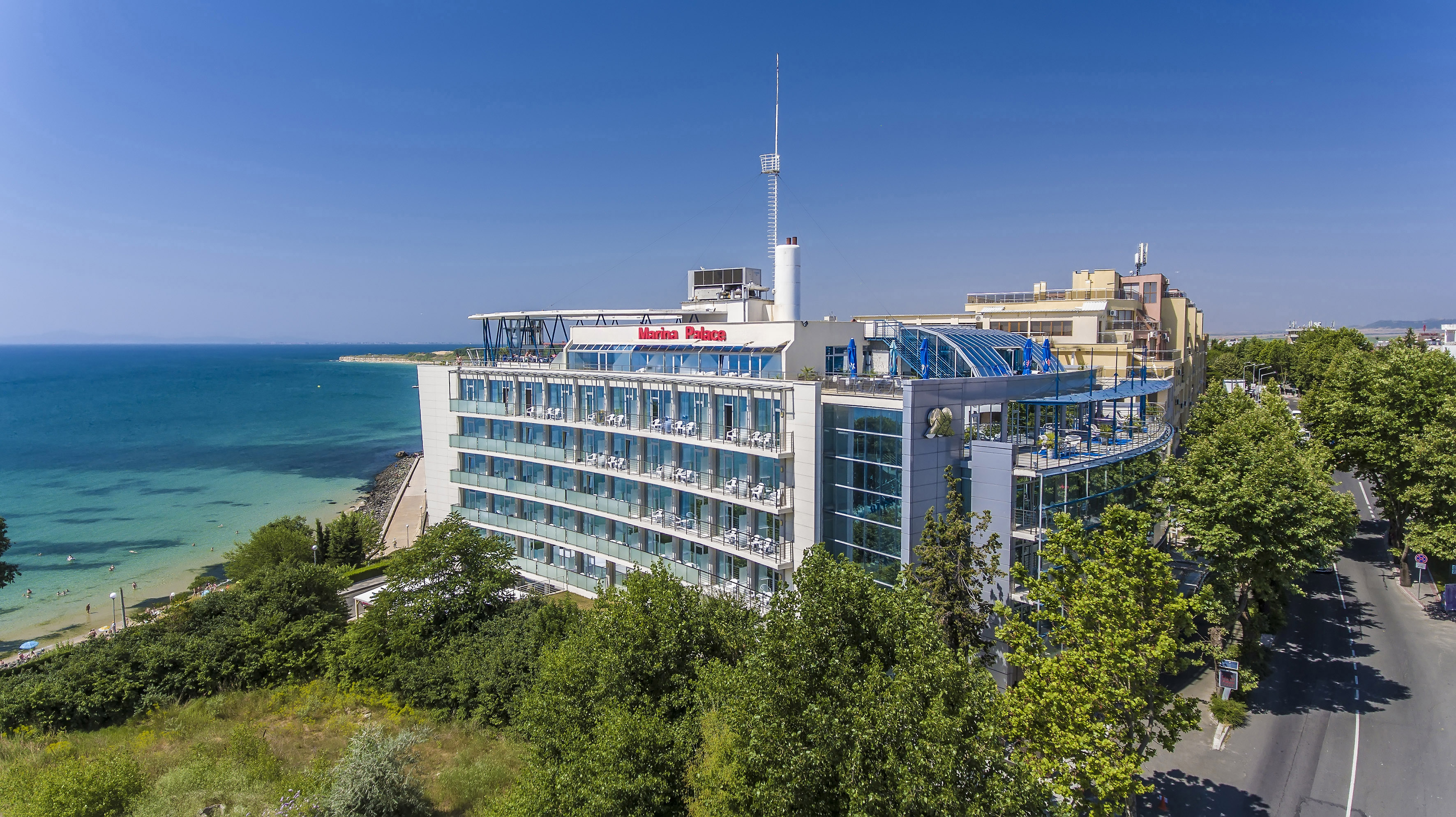 a building with many windows and a body of water