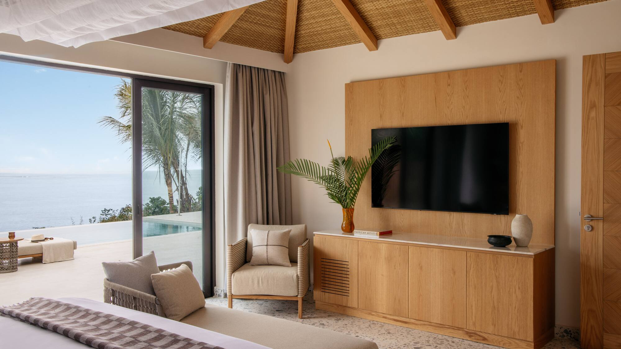 a room with a television and a large bed