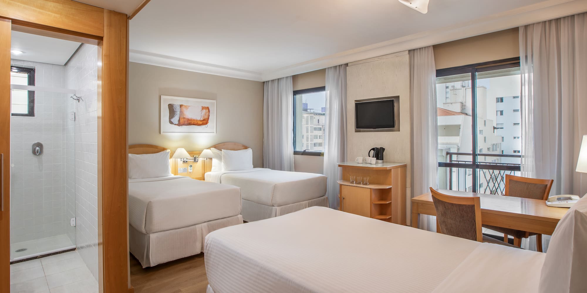 a room with two beds and a table