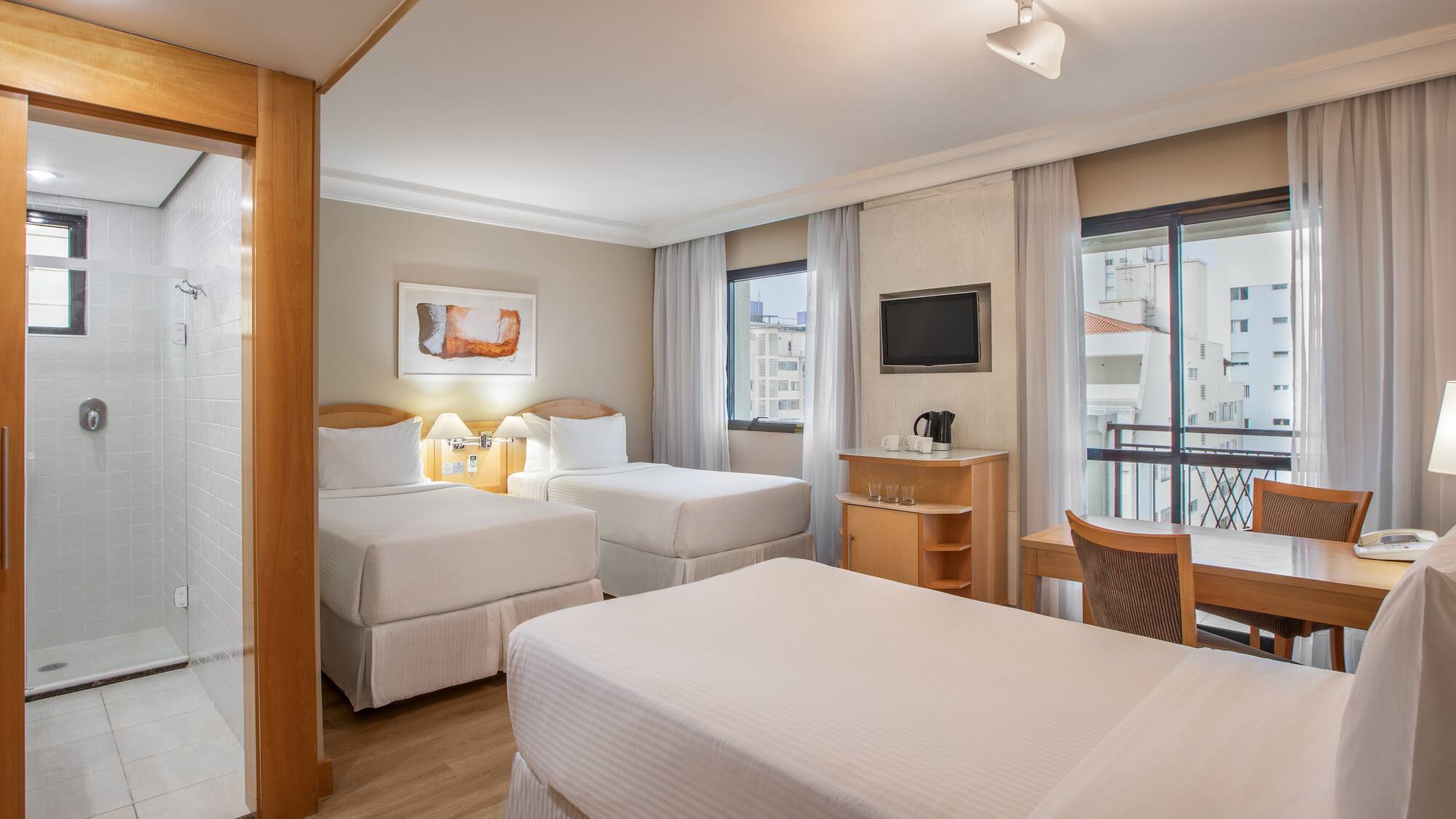 a room with two beds and a table