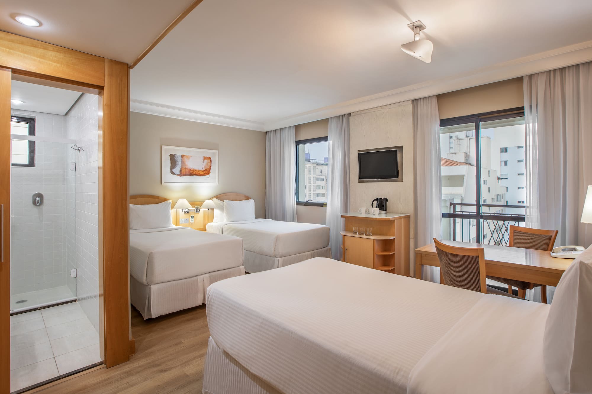 a room with two beds and a table