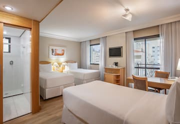 a room with two beds and a table