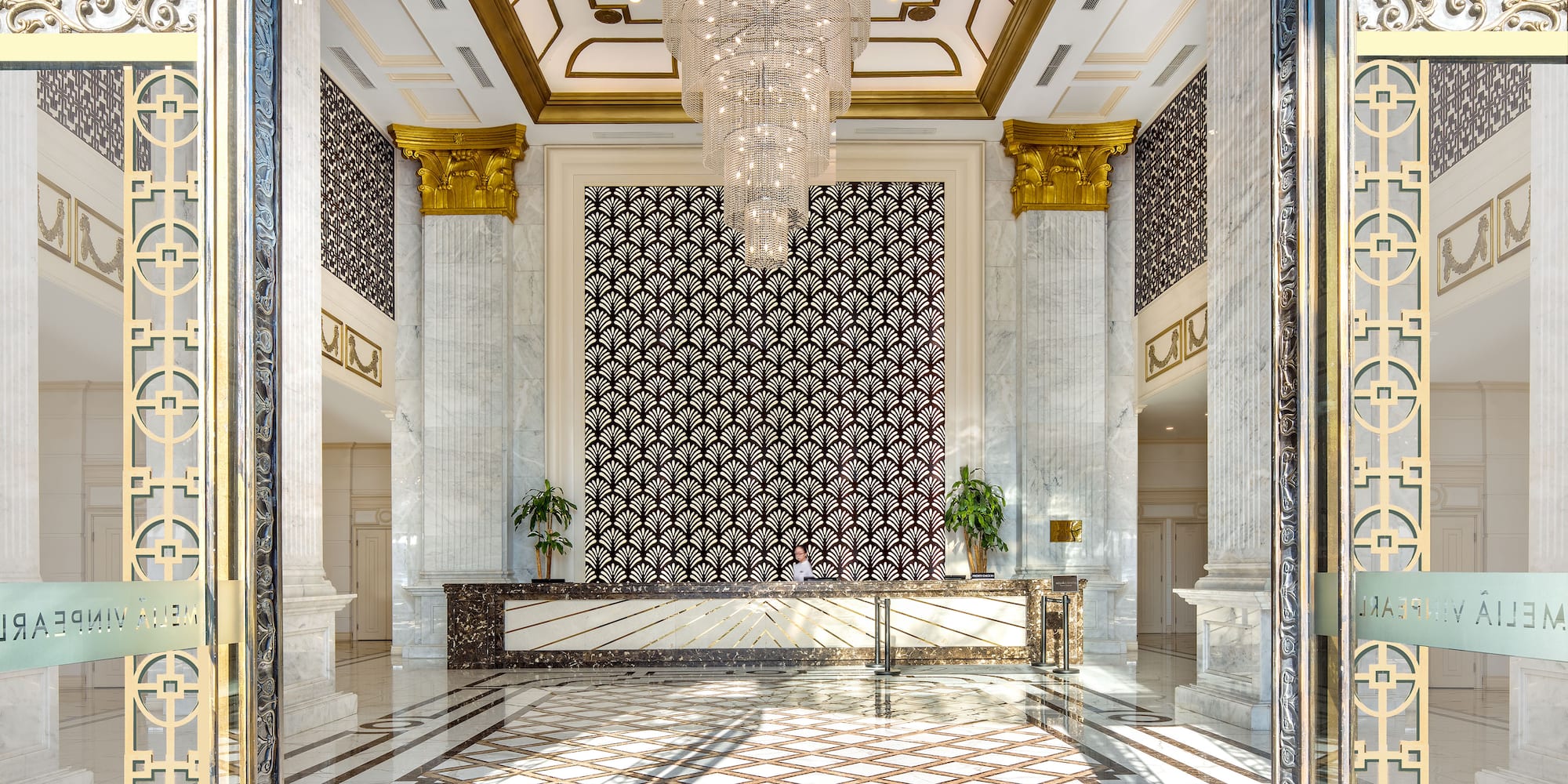 a lobby with a chandelier and marble floor