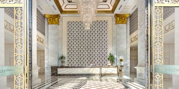 a lobby with a chandelier and marble floor