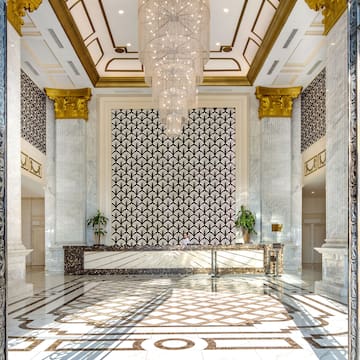 a lobby with a chandelier and marble floor