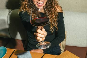 a woman holding a glass of wine