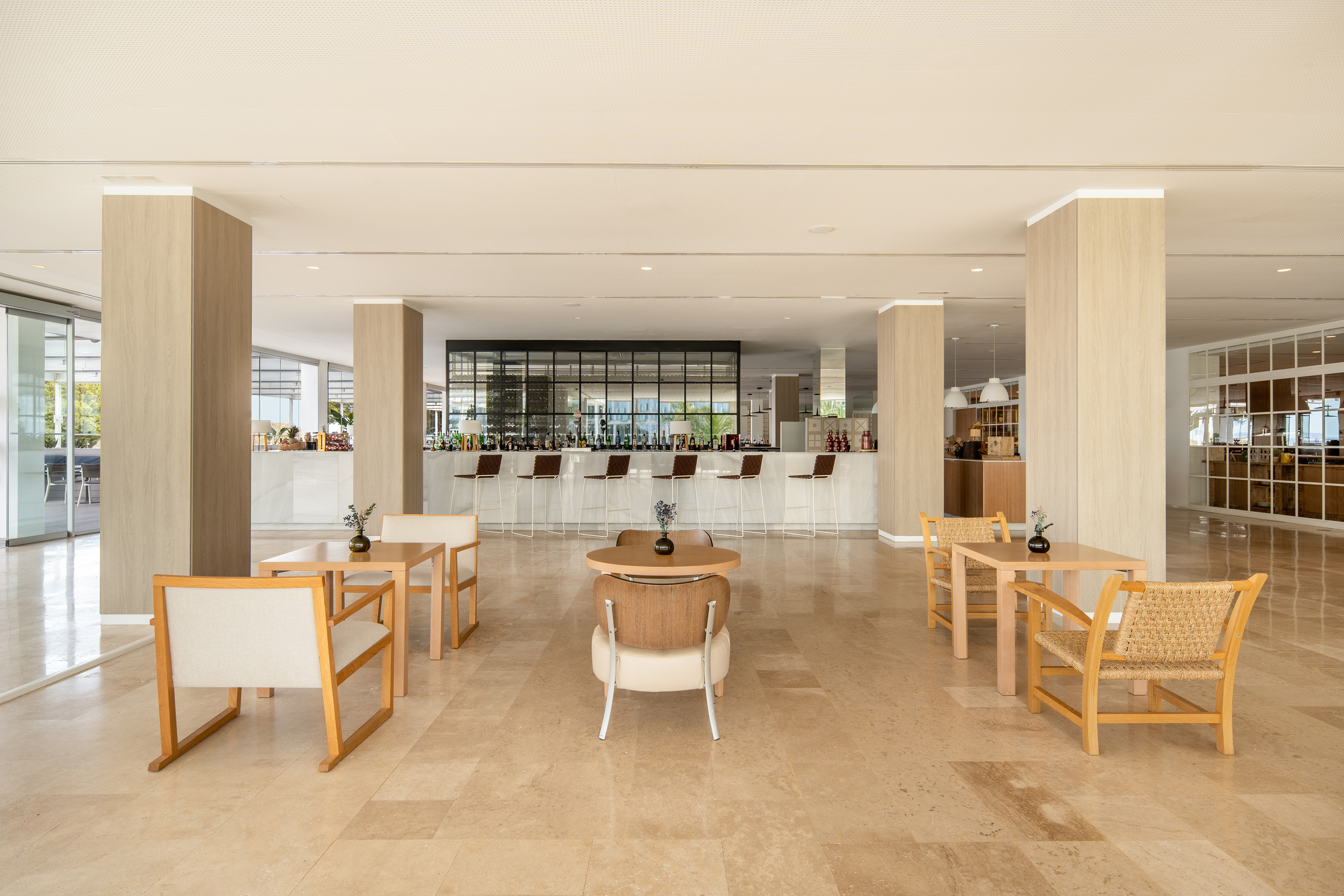 Modern hotel bar and lounge with bar stools and stylish seating.