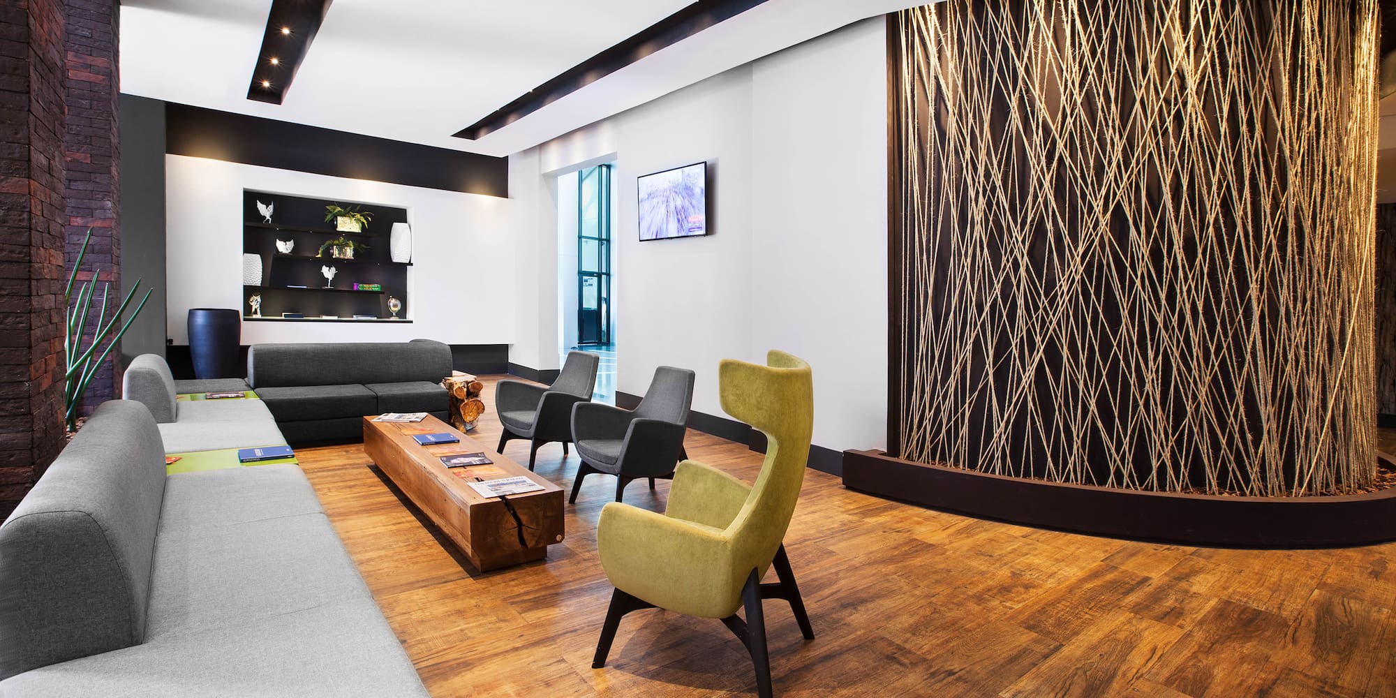 a room with a couch and chairs