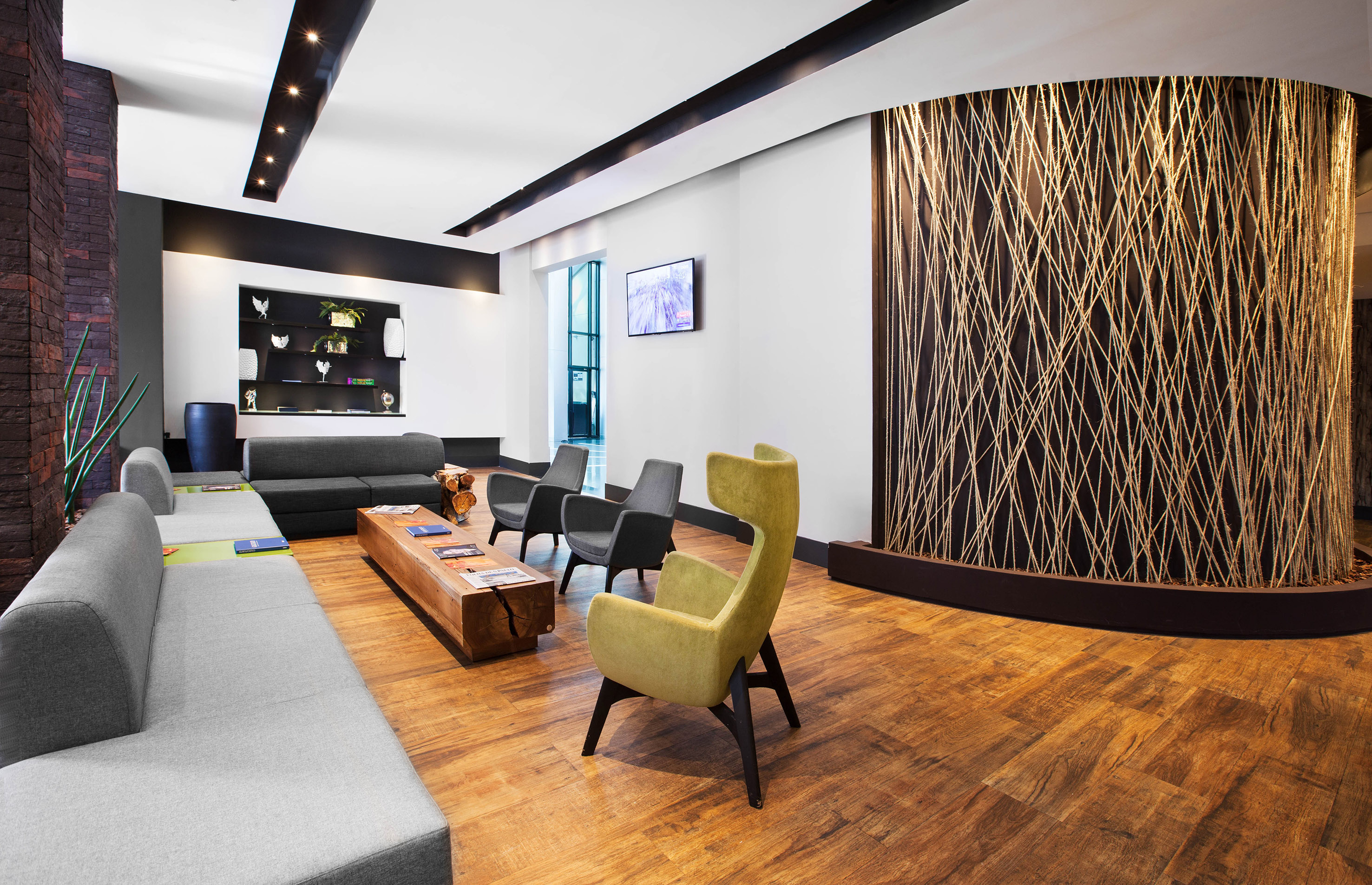 a room with a couch and chairs