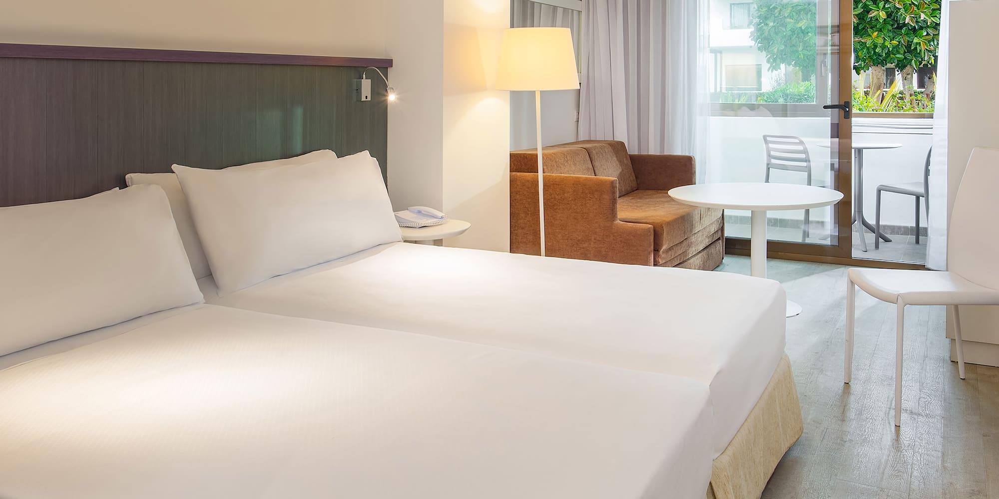 a room with two beds and a couch