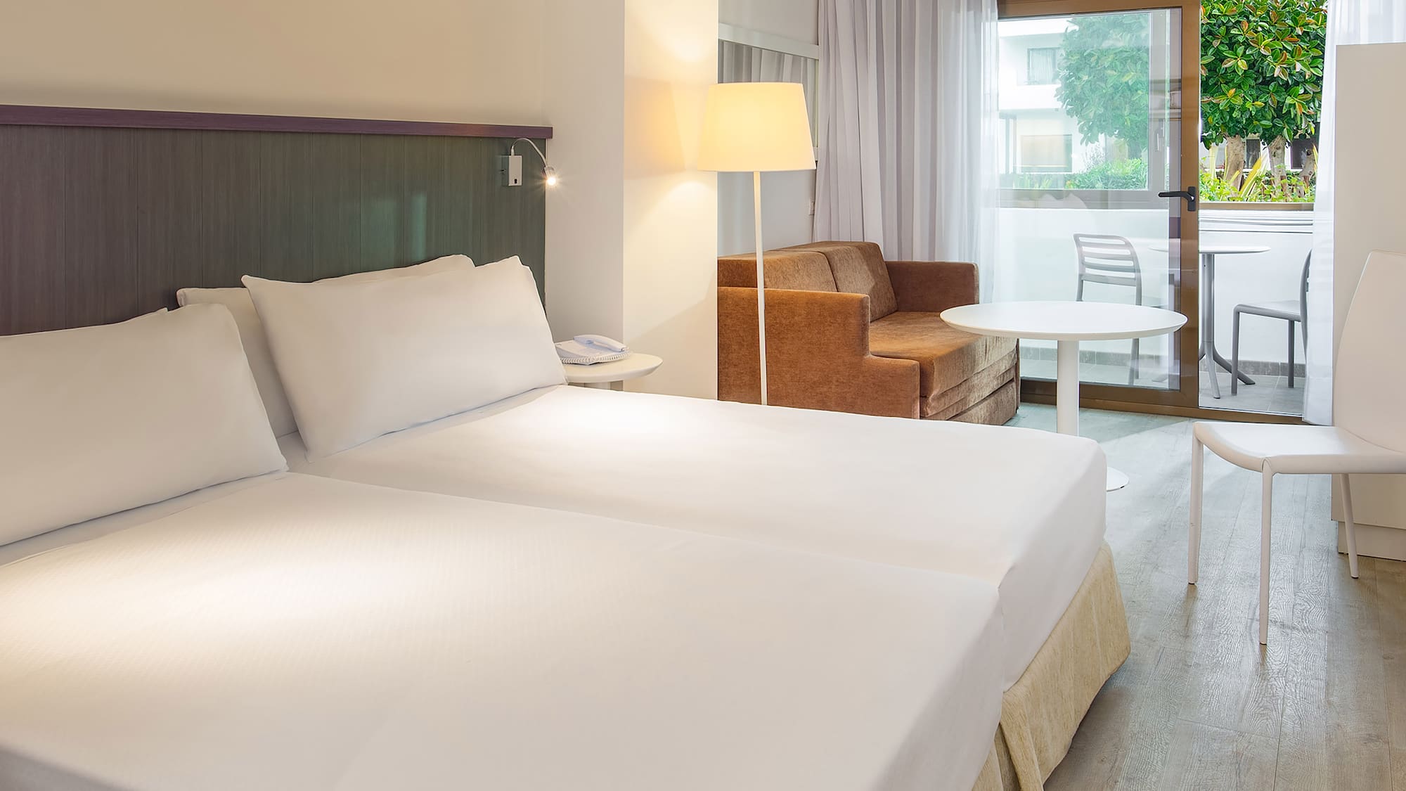 a room with two beds and a couch