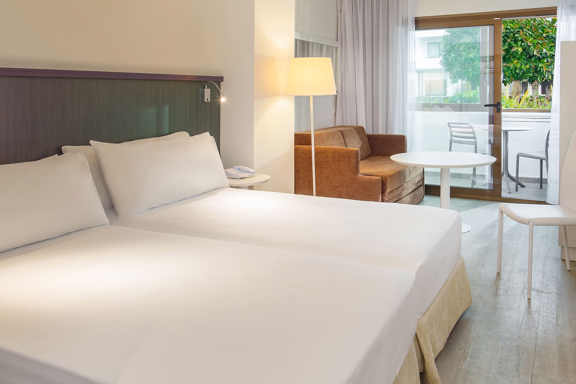 a room with two beds and a couch