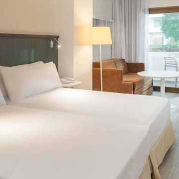 a room with two beds and a couch