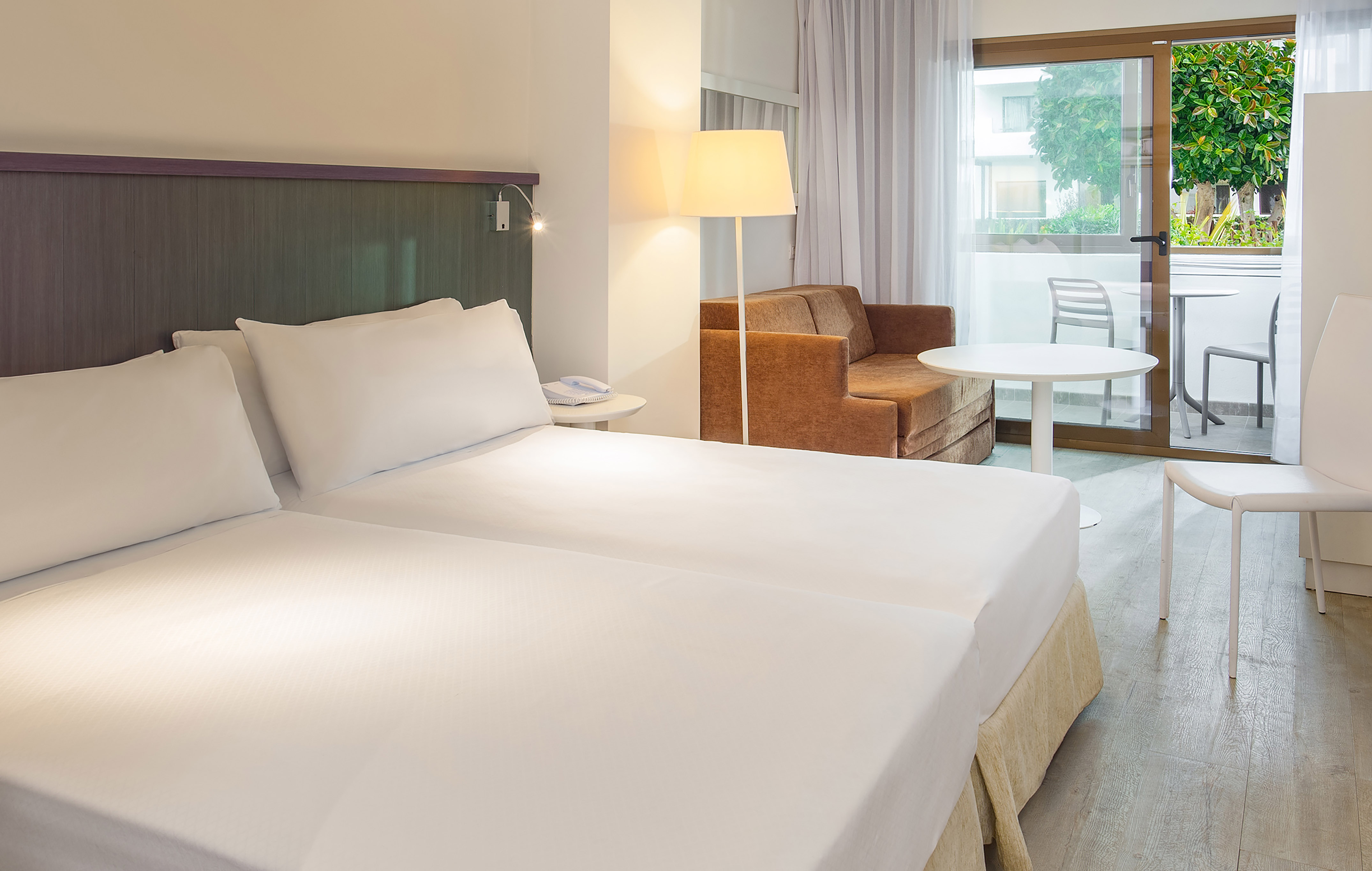 a room with two beds and a couch