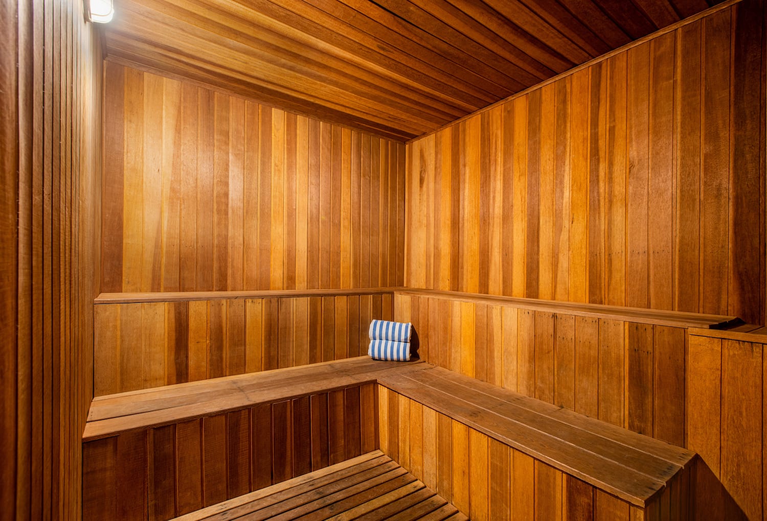 a wooden sauna with a towel on the seat