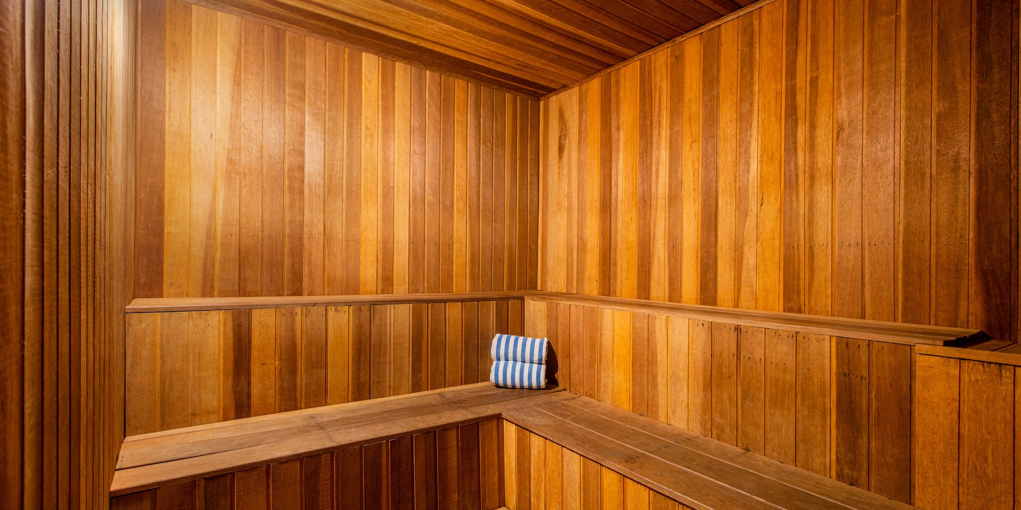 a wooden sauna with a towel on the seat