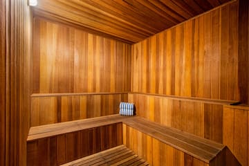 a wooden sauna with a towel on the seat
