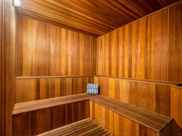 a wooden sauna with a towel on the seat