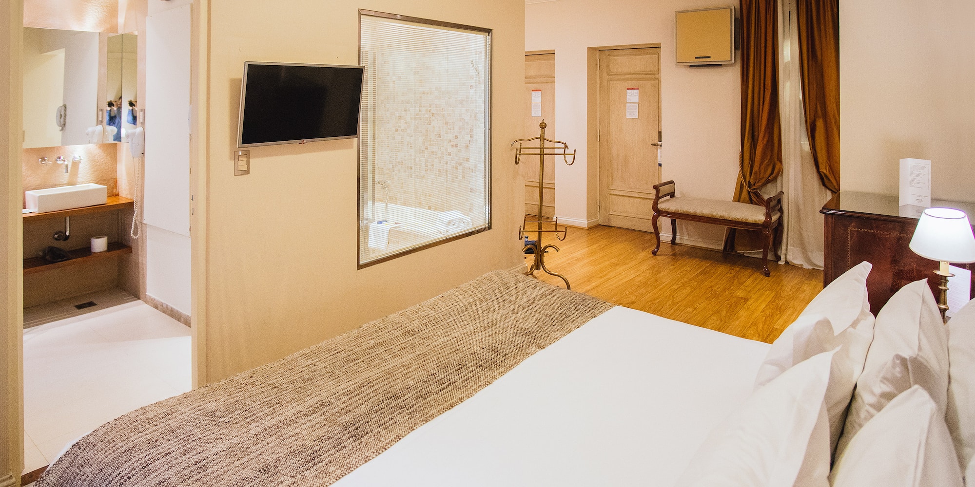 a room with a bed and a mirror