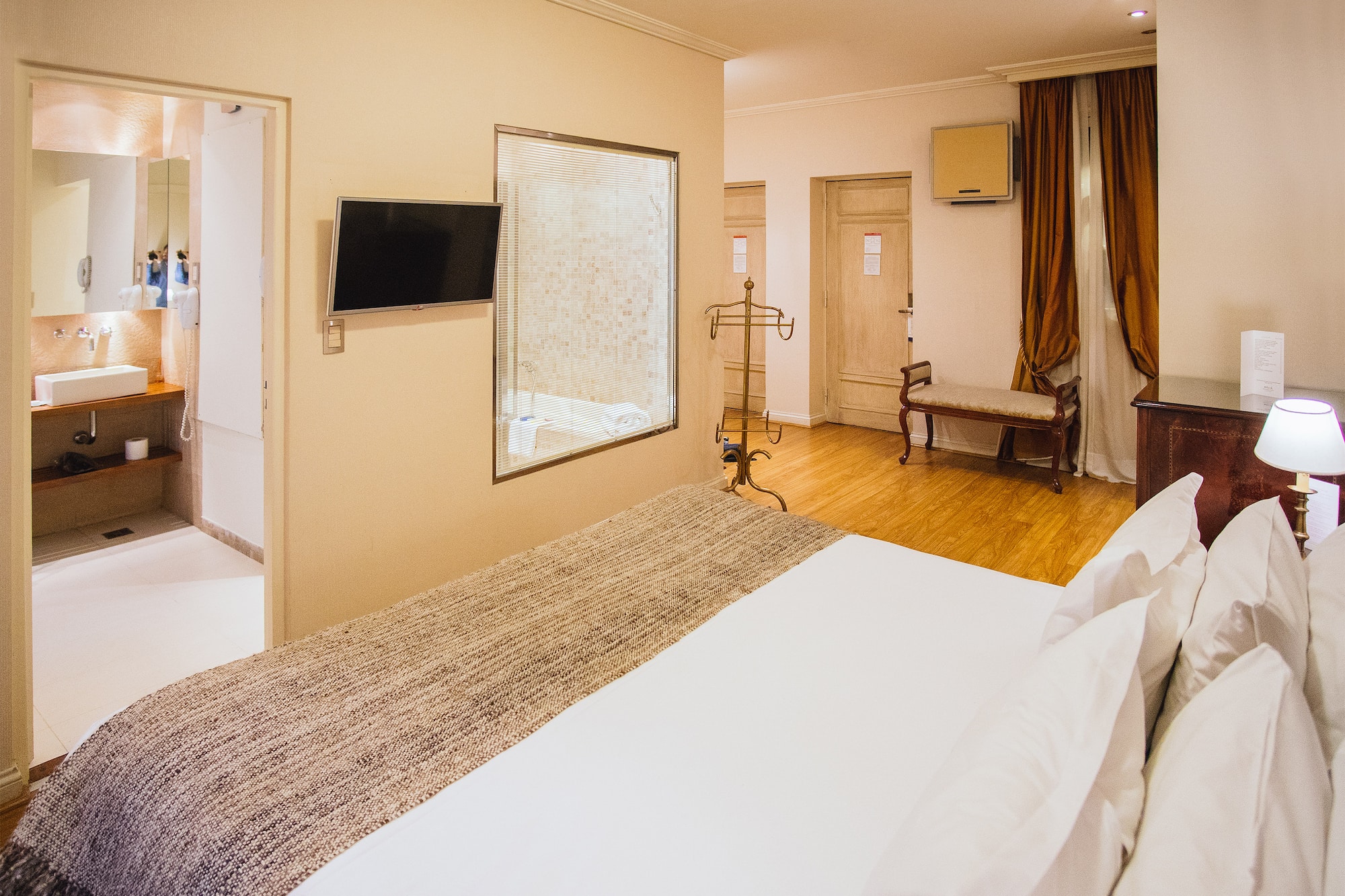 a room with a bed and a mirror