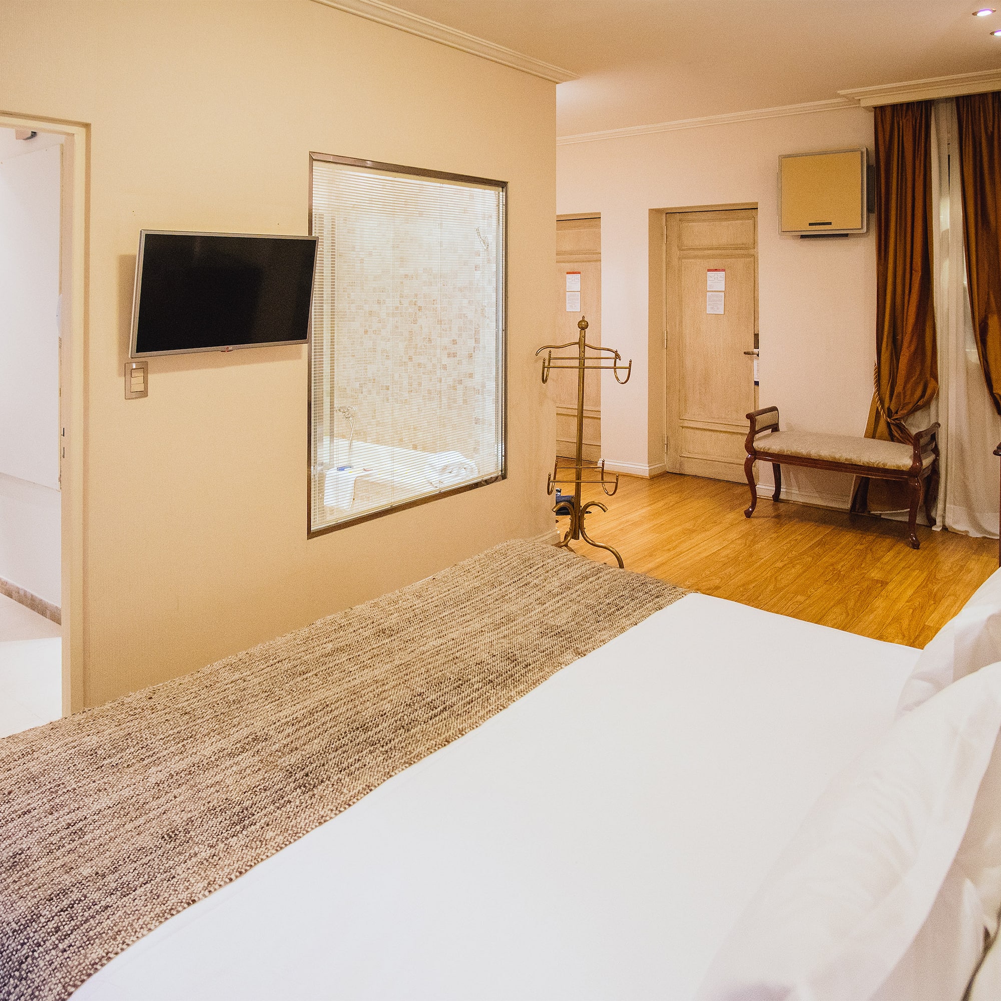 a room with a bed and a mirror